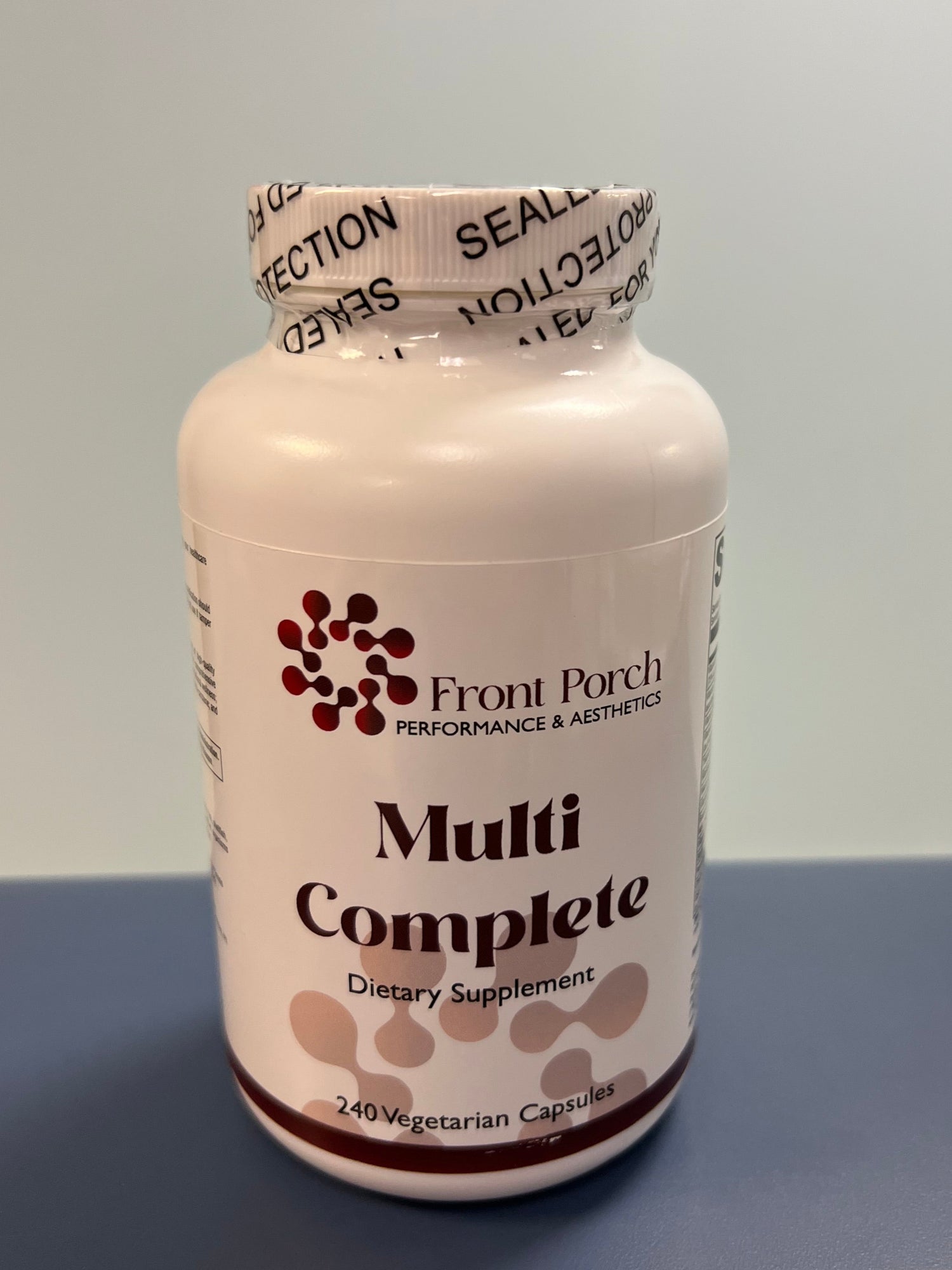 Bottle of Front Porch Pet Multi Complete supplement on a blue background
